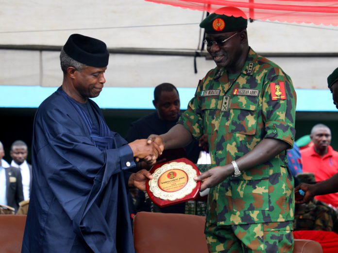 Vice President Yemi Osinajo receiving a plaque from the COAS