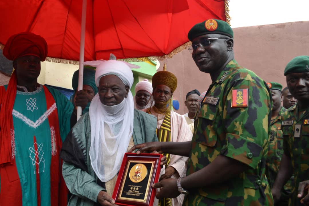 Nigeria"s Army Chief Lt Gen TY Buratai presents a souvenir to His Royal Highness, the Emir of Daura, Alhaji Umar Farouk Umar CFR, when he paid Sallah homage to the revered Emir on 15 August 2019. .