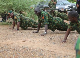 Lt Gen TY Buratai (middle) leads troops to series of Push-Ups during the visit.