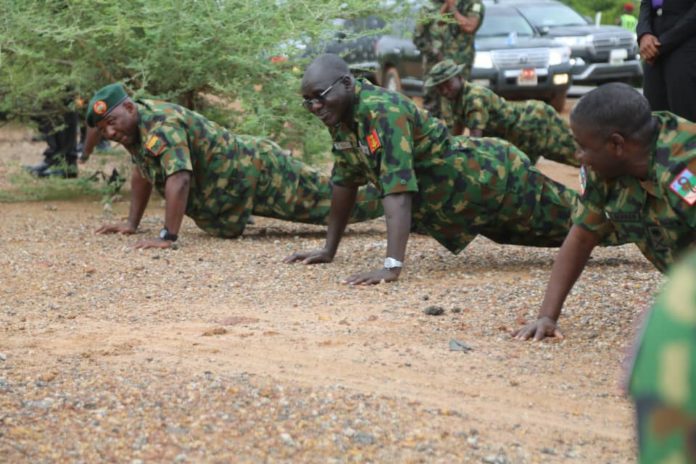 Lt Gen TY Buratai (middle) leads troops to series of Push-Ups during the visit.