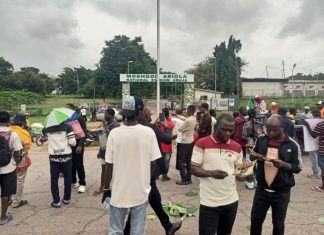 Security operatives disperse protesters with teargas at Abuja stadium