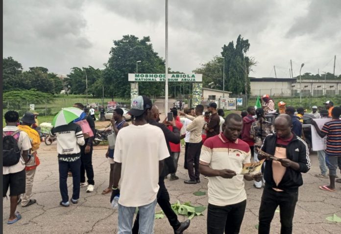 Security operatives disperse protesters with teargas at Abuja stadium