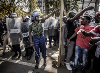 Zimbabwe arrests 18 activists, warns against protests