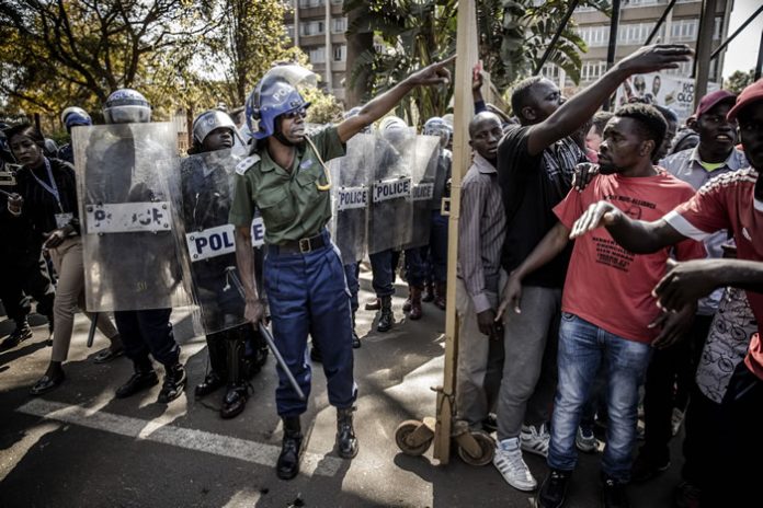 Zimbabwe arrests 18 activists, warns against protests