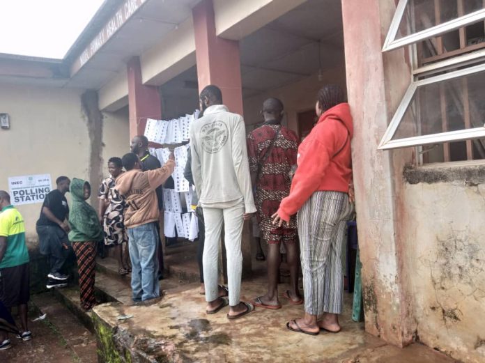 Residents defy rains as voting begins