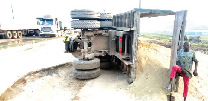 Driver, motor boy escape death as truck tumbles in Ogun